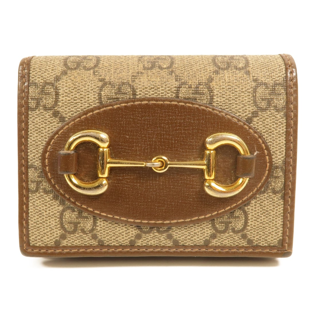 GUCCI Horsebit 1955 Bi Fold Wallet 621887 Brown PVC Canvas: GUCCI Horsebit 1955 Bi Fold Wallet 621887 Brown PVC Canvas GUCCI bi-fold wallet in brown PVC coated canvas with a Horsebit 1955 design. It features a hook button closure, a coin case, and space for si