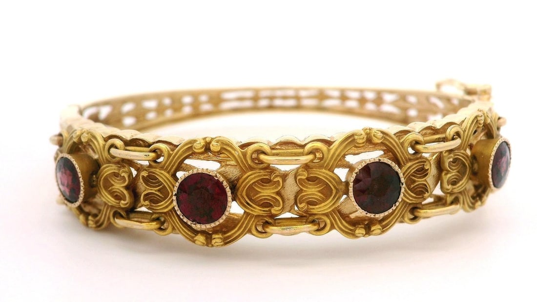 Vintage 14k Yellow Gold Garnet Open Work Bangle Bracelet: Vintage 14k Yellow Gold Garnet Open Work Bangle Bracelet This vintage bangle bracelet showcases a stunning design crafted from solid 13-14k yellow gold. It features four natural genuine garnets in an 