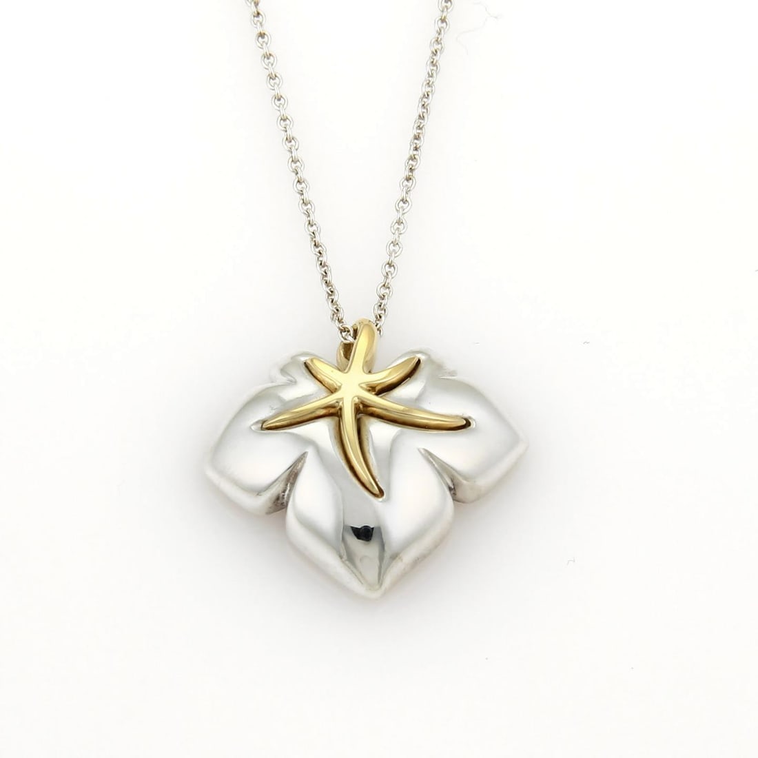 Tiffany & Co. Ivy Starfish Pendant 18k Gold Sterling Silver Necklace: Tiffany & Co. Ivy Starfish Pendant 18k Gold Sterling Silver Necklace This exquisite Tiffany & Co. Ivy Starfish Pendant Necklace showcases an elegant blend of 925 Sterling silver and 18k yellow gold. T