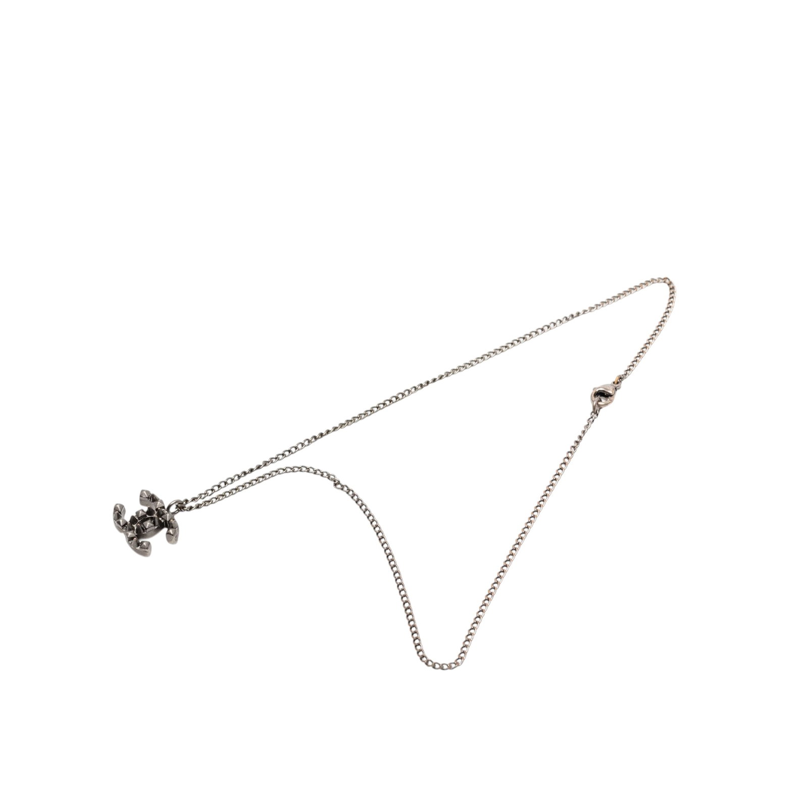 Chanel gunmetal CC pendant necklace spike brass: Chanel gunmetal CC pendant necklace spike brass This Chanel necklace features a gunmetal-tone metal body and a distinctive CC pendant with spike detailing. It is secured with a lobster clasp closure. 