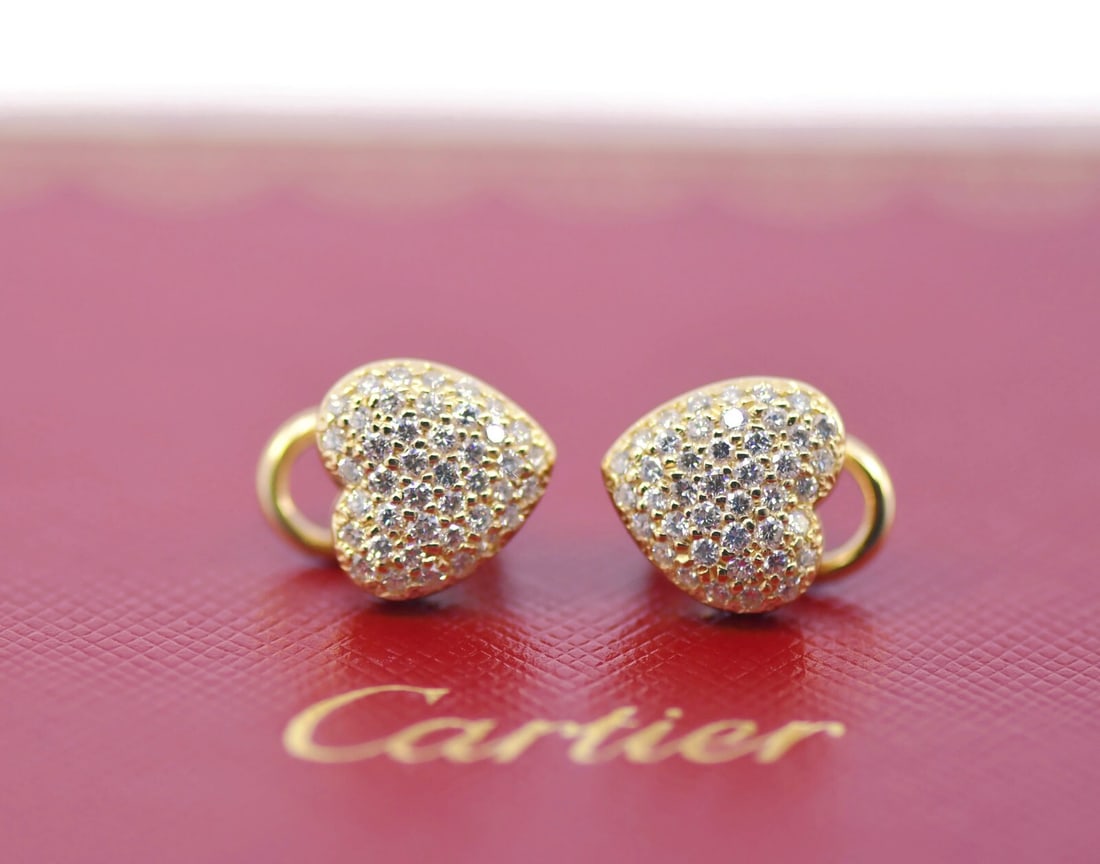 18K Yellow Gold Diamond Heart Stud Earrings: 18K Yellow Gold Diamond Heart Stud Earrings These elegant stud earrings feature heart-shaped designs crafted from 18K yellow gold and set with diamonds. Measuring 11 x 10 mm and weighing 6 grams, they