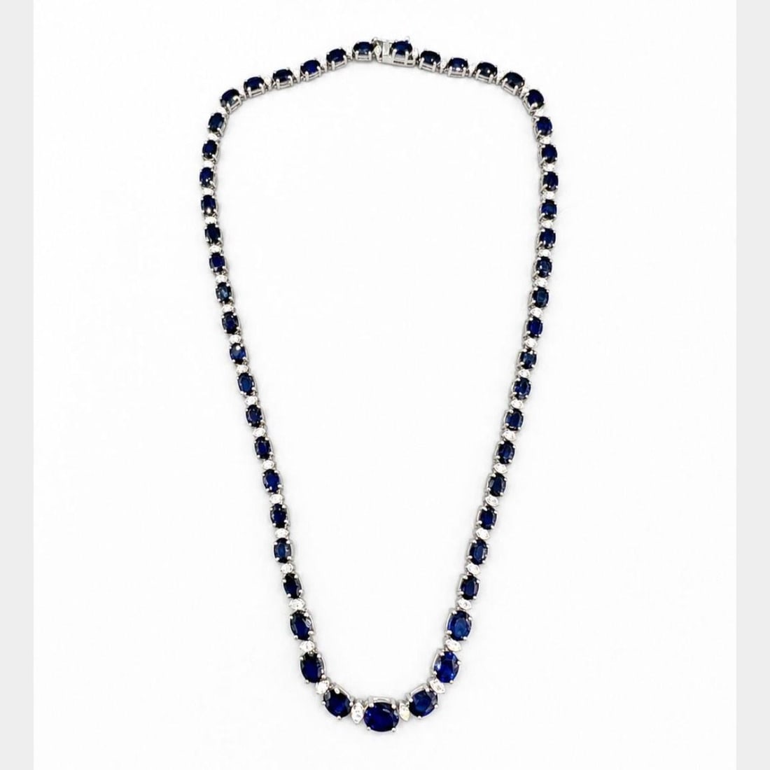 Graduated Sapphire and Diamond Necklace in 14K White Gold 16.75 in: Graduated Sapphire and Diamond Necklace in 14K White Gold 16.75 in Elegant 14K white gold graduated necklace set with sapphires and diamonds. The design features 51 sapphires with an approximate total