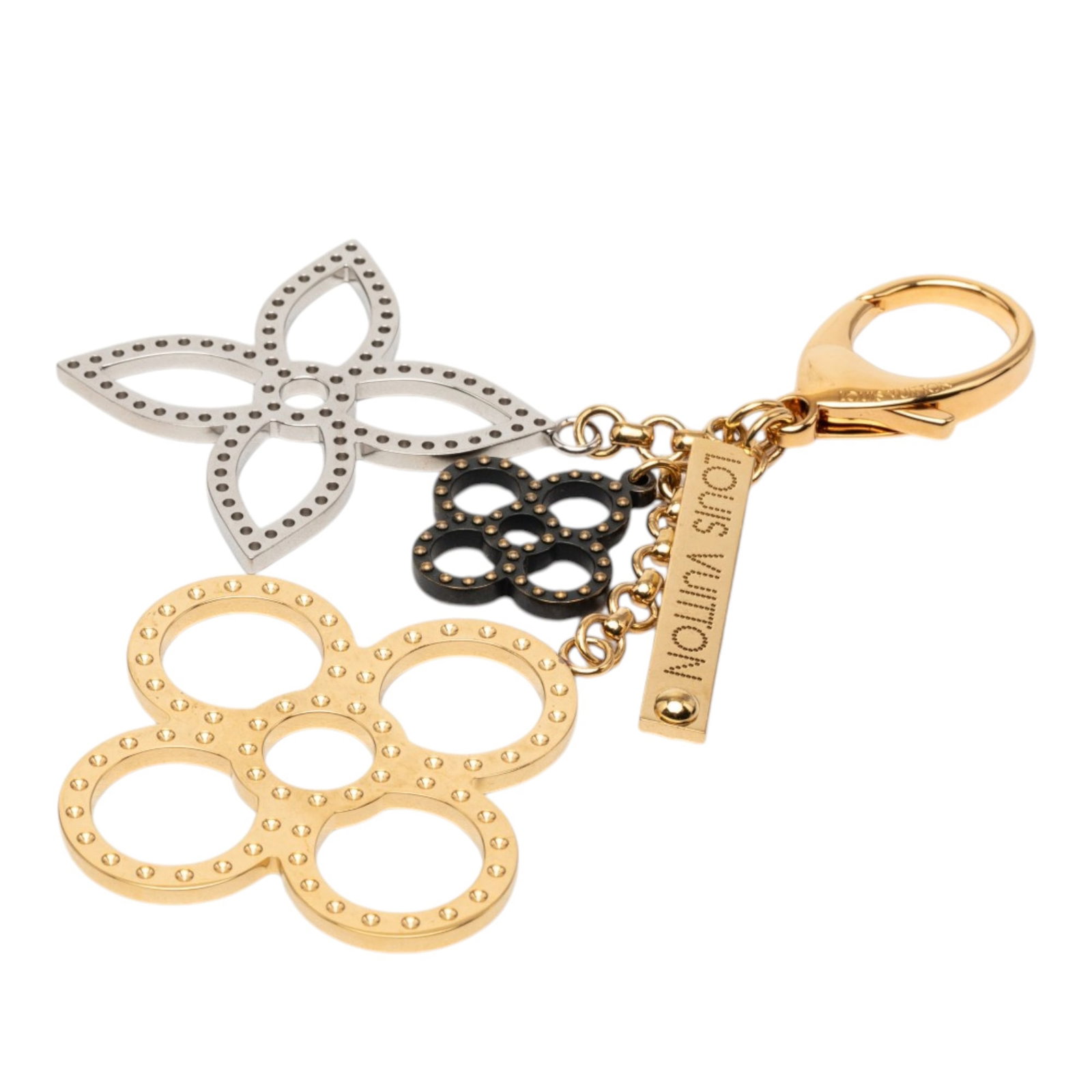 Louis Vuitton Bijoux Sac Tapage gold-tone bag charm: Louis Vuitton Bijoux Sac Tapage gold-tone bag charm This Louis Vuitton Bijoux Sac Tapage bag charm features a gold-tone and silver-tone metal construction with a lobster clasp closure. It is designed 