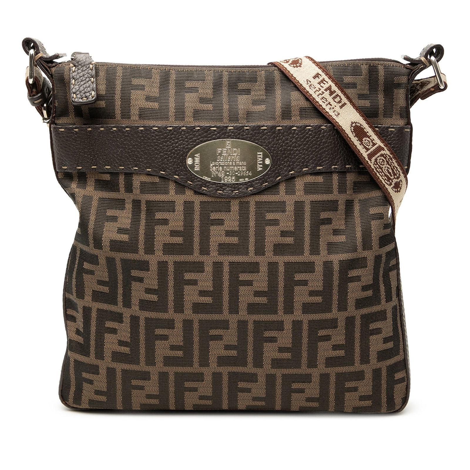 Fendi Selleria Brown Canvas Crossbody Bag with Leather Trim: Fendi Selleria Brown Canvas Crossbody Bag with Leather Trim The Fendi Zucca Canvas Selleria Crossbody is crafted with a canvas body accented by leather trim. It features an adjustable flat canvas stra