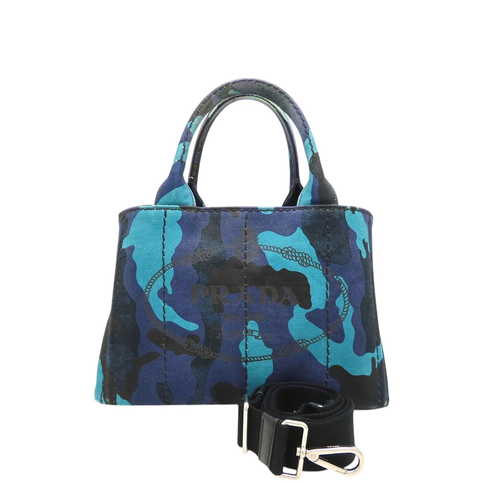 Prada Canapa Small Blue Camouflage Canvas Tote Bag: Prada Canapa Small Blue Camouflage Canvas Tote Bag Prada Small Canvas Canapa Logo Camouflage Tote satchel in blue fabric with a canvas body. It features rolled top handles, a detachable flat strap, an