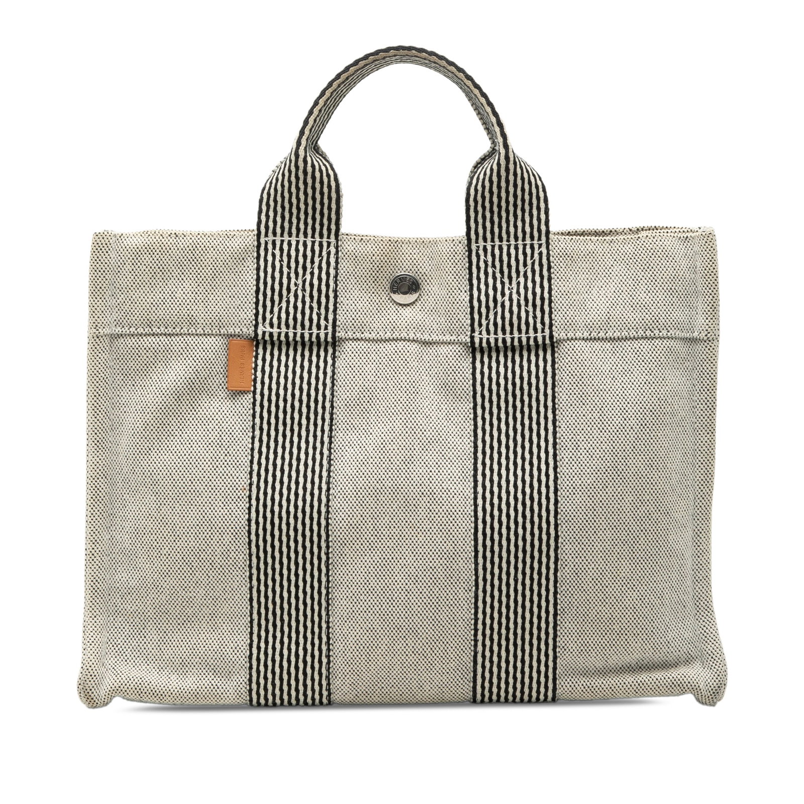 Hermes Fourre Tout PM Gray Canvas Tote Bag: Hermes Fourre Tout PM Gray Canvas Tote Bag This Hermes Fourre Tout PM tote bag is crafted from durable canvas in a gray color. It features flat handles, an open top with a snap button closure, and an 