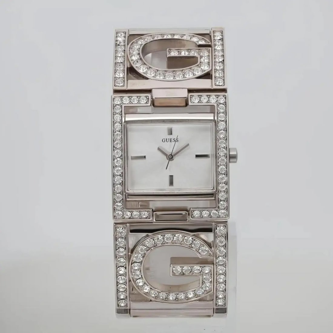 GUESS Ladies Quartz Watch G Link Silver Dial Gem-Set Bezel Bracelet: GUESS Ladies Quartz Watch G Link Silver Dial Gem-Set Bezel Bracelet This elegant Guess G Link wristwatch is a perfect blend of style and functionality. Designed for ladies, it features a striking silv
