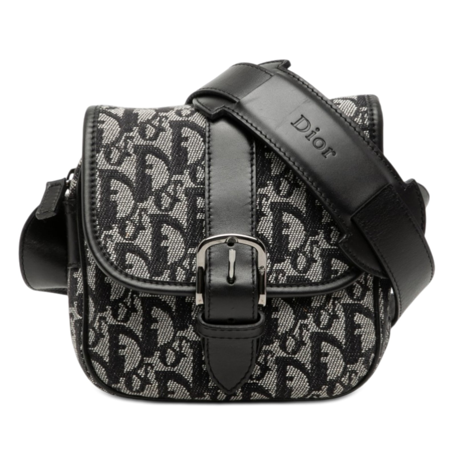 Dior crossbody bag in canvas with leather trim: Dior crossbody bag in canvas with leather trim This Diorissimo Trotter Canvas Crossbody bag features a canvas body with leather trim, an adjustable flat strap, a front flap with buckle closure, a top 