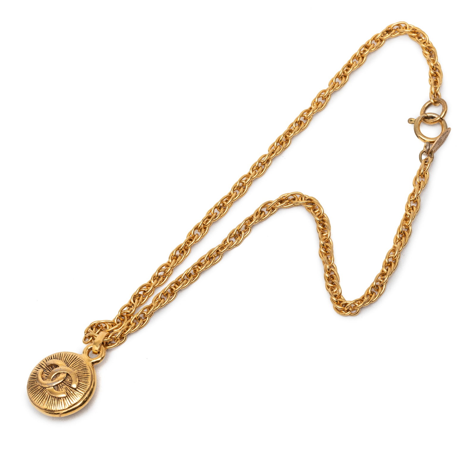Chanel CC Sunburst Round Pendant Necklace Gold Plated Metal: Chanel CC Sunburst Round Pendant Necklace Gold Plated Metal Gold plated metal necklace with a round pendant and spring ring closure. It is described as a costume piece from France in gold color, with 