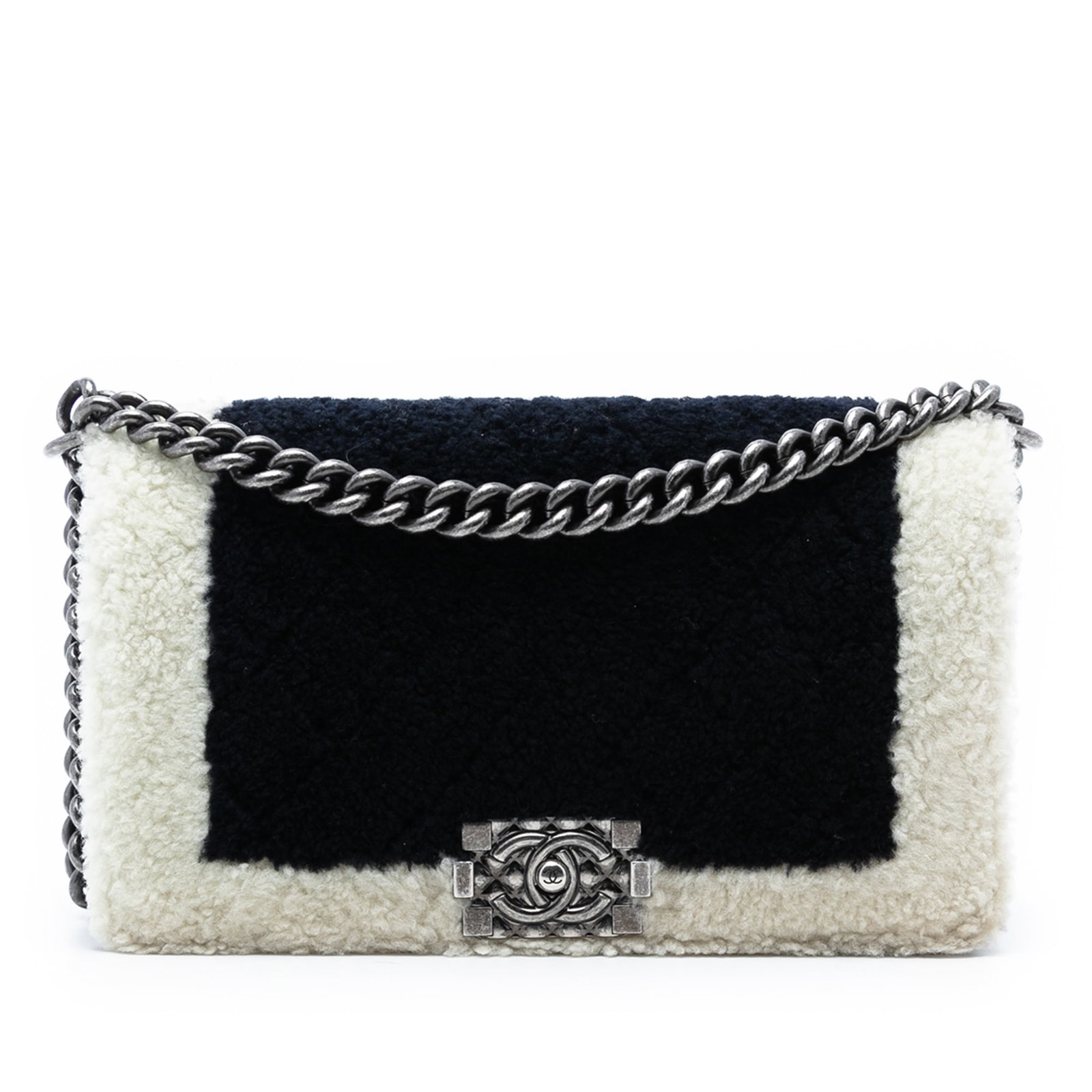 Chanel Old Medium Bicolor Shearling Boy Flap Bag: Chanel Old Medium Bicolor Shearling Boy Flap Bag Introducing the Chanel Old Medium Bicolor Shearling Boy Flap, a stylish and contemporary bag that combines luxury with functionality. This exquisite pi