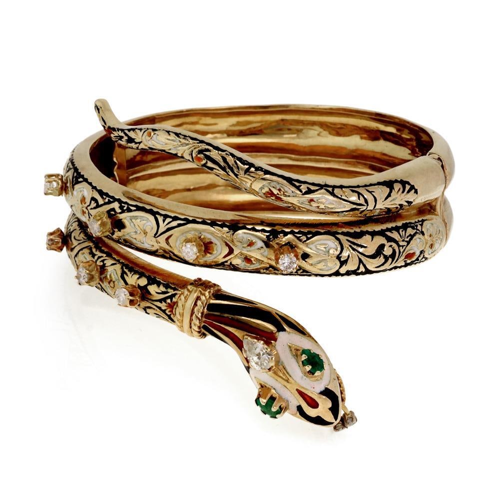 14k Yellow Gold Enamel Snake Bangle with Diamonds and Emeralds: 14k Yellow Gold Enamel Snake Bangle with Diamonds and Emeralds This exquisite Estate bracelet showcases a stunning coiled snake design, crafted from 14k yellow gold. The front of the bracelet features