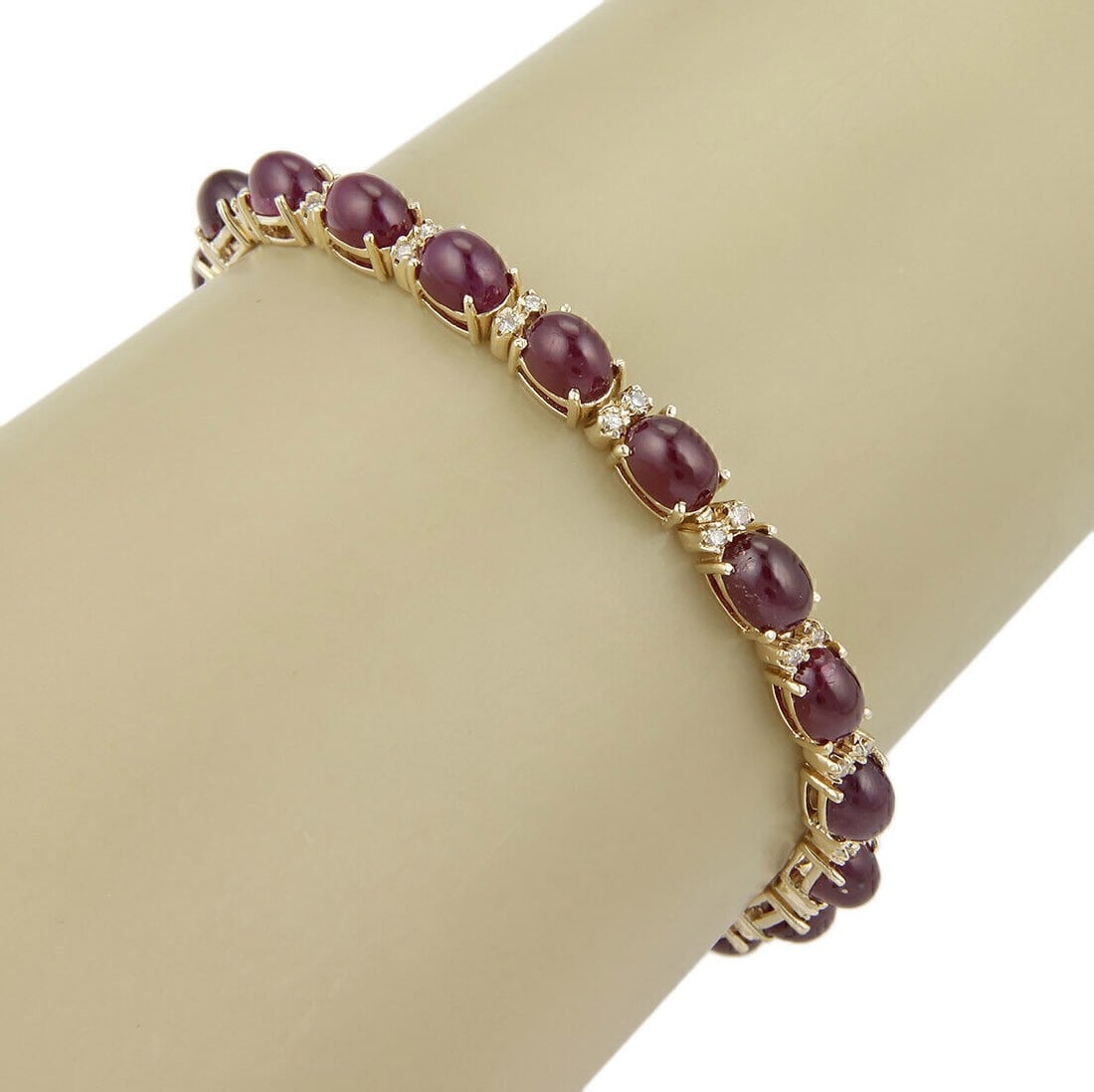 Vintage 14k Yellow Gold Tennis Bracelet with Cabochon Rubies and Diamonds: Vintage 14k Yellow Gold Tennis Bracelet with Cabochon Rubies and Diamonds This vintage/estate tennis bracelet is crafted in 14k yellow gold and features cabochon rubies accented with diamonds. It is d