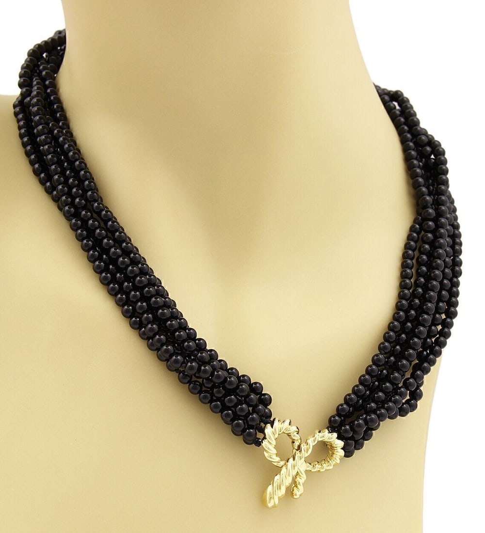 Tiffany & Co. Bow Pendant Necklace in 18k Gold with Multi Strand Onyx Beads: Tiffany & Co. Bow Pendant Necklace in 18k Gold with Multi Strand Onyx Beads An authentic Tiffany & Co. necklace crafted in 18k yellow gold with multi-strand onyx beads and a bow pendant centerpiece. T