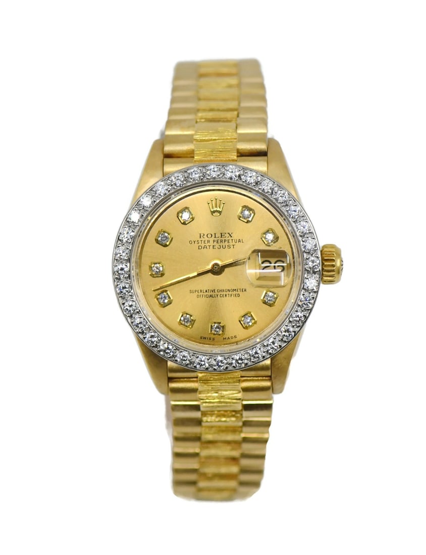 Rolex Datejust 6927 womens 18K yellow gold watch aftermarket diamonds: Rolex Datejust 6927 womens 18K yellow gold watch aftermarket diamonds Pre-owned Rolex Datejust wristwatch for women, manufactured in 1979. It features an 18K yellow gold case and band, an aftermarket 