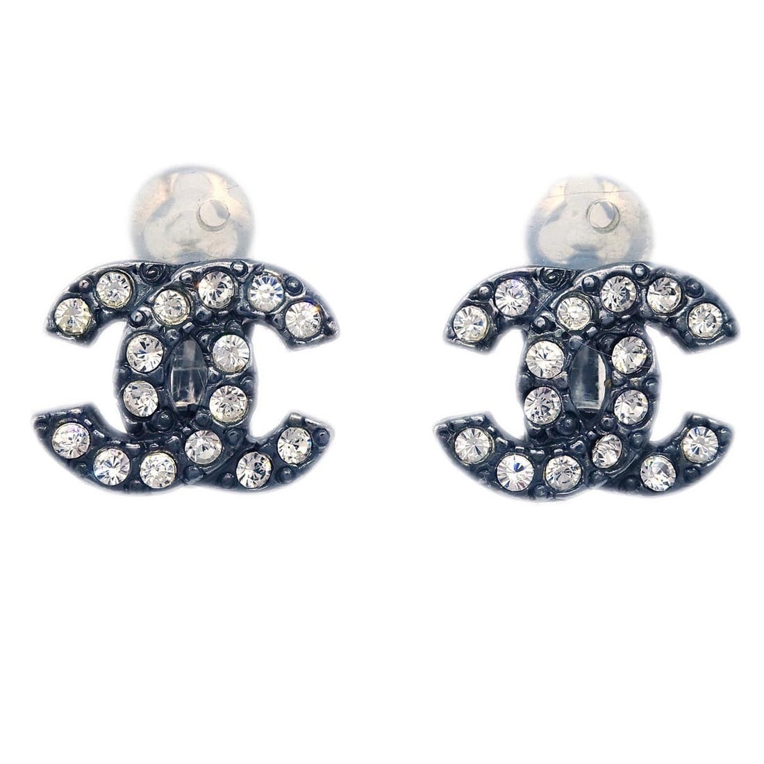 CHANEL 04A Black Rhinestone Clip-On Button Earrings: CHANEL 04A Black Rhinestone Clip-On Button Earrings Clip-on Chanel CC button-style earrings in black with rhinestone detailing. Made in France, these silver-plated earrings are marked 04A and are pres