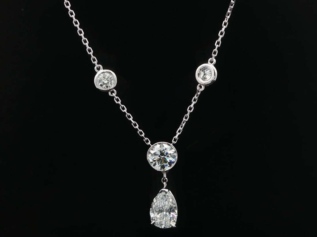GIA Certified 4.21ct Pear and Round Diamond White Gold Pendant Necklace: GIA Certified 4.21ct Pear and Round Diamond White Gold Pendant Necklace This un-used necklace features a pendant with a total of 4.21 carats of natural diamonds, including both pear and round brillian