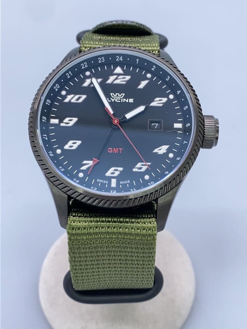 Glycine GL1006 GMT Quartz Black Khaki Wristwatch: Glycine GL1006 GMT Quartz Black Khaki Wristwatch This Glycine GMT Quartz GL1006 men's wristwatch features a black and khaki color scheme and is crafted in Switzerland. The watch is in pre-owned condit