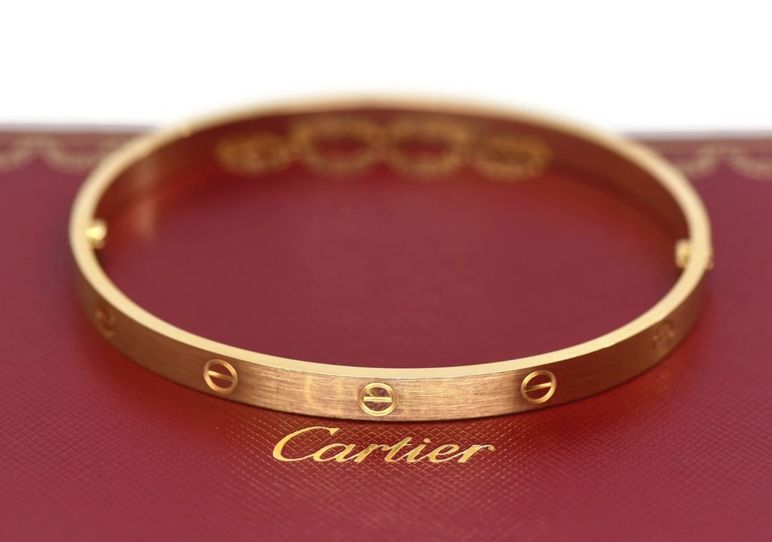 Cartier Love Bangle Bracelet 18K Yellow Gold Size 22: Cartier Love Bangle Bracelet 18K Yellow Gold Size 22 This Cartier Love bracelet is crafted from 18k yellow gold with a brushed finish. Featuring the iconic Love design, this bangle is size 22, measure
