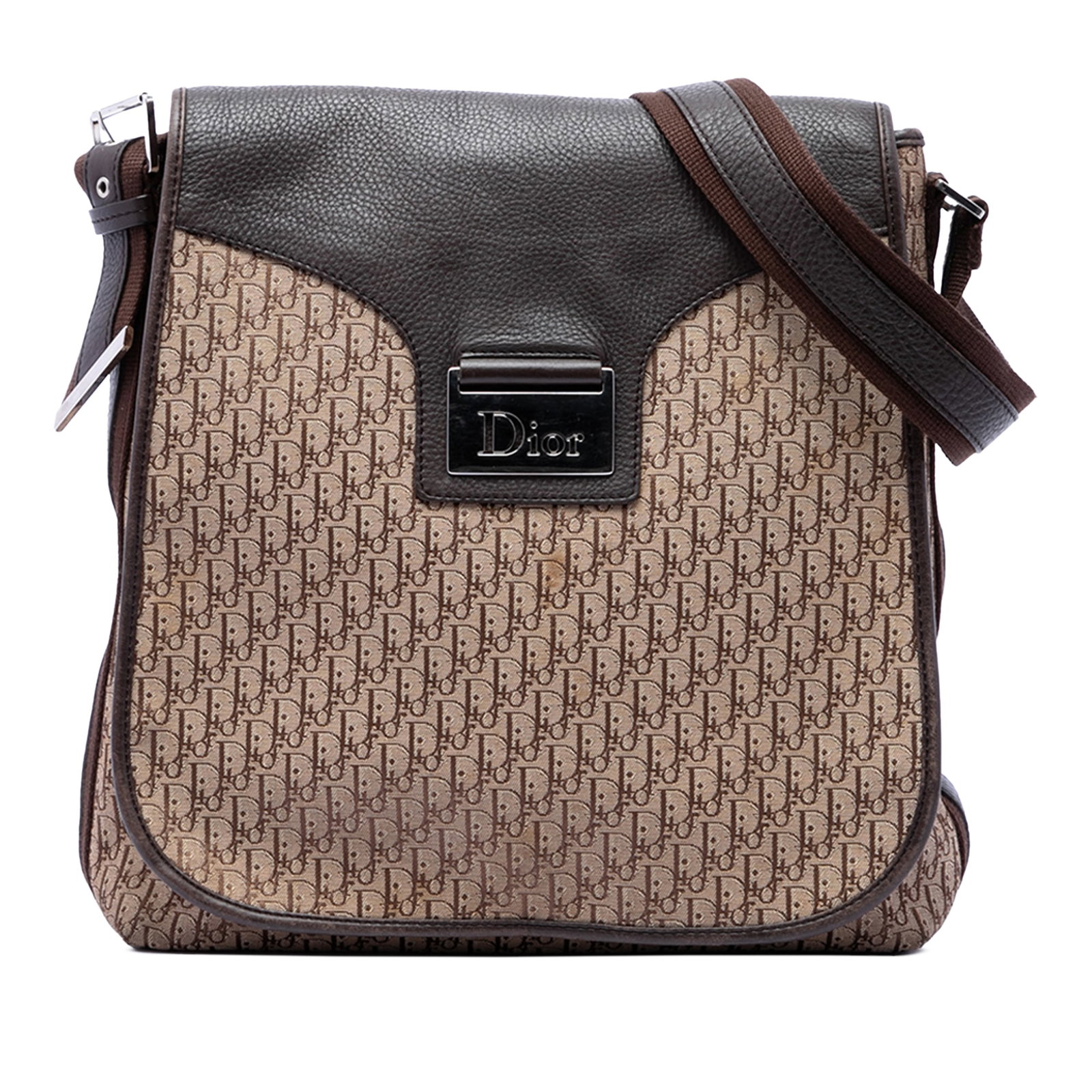 Dior Brown Canvas Leather Trim Crossbody Bag: Dior Brown Canvas Leather Trim Crossbody Bag This Diorissimo Trotter Canvas Street Chic Crossbody bag features a canvas body with leather trim and an adjustable flat strap for versatile wear. It is de