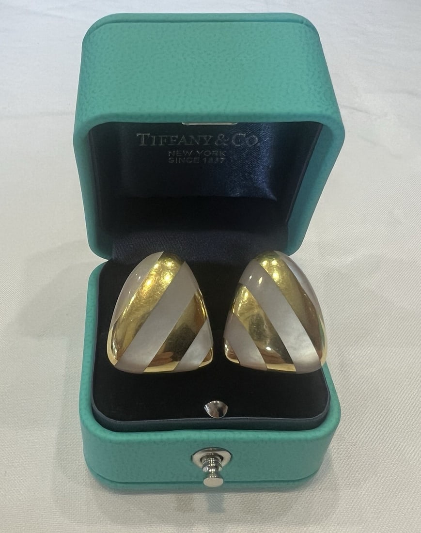 Tiffany & Co 18K Yellow Gold Mother of Pearl Cuff Earrings with Box: Tiffany & Co 18K Yellow Gold Mother of Pearl Cuff Earrings with Box This elegant pair of Tiffany & Co. cuff-style earrings is expertly crafted in 18k yellow gold and features mother-of-pearl inlays. M