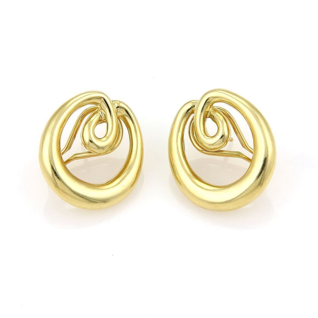 Tiffany & Co. 18k Yellow Gold Double Loop Open Oval Earrings: Tiffany & Co. 18k Yellow Gold Double Loop Open Oval Earrings Tiffany & Co. double loop open oval huggie earrings crafted in 18k yellow gold. The earrings feature a bold sculptural overlapping loop des