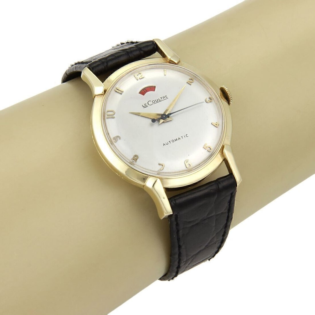 Mens Le Coultre automatic wristwatch 14k gold case black leather strap: Mens Le Coultre automatic wristwatch 14k gold case black leather strap This Le Coultre men's automatic wristwatch features a 14k gold case paired with a black leather band for a classic vintage look. 