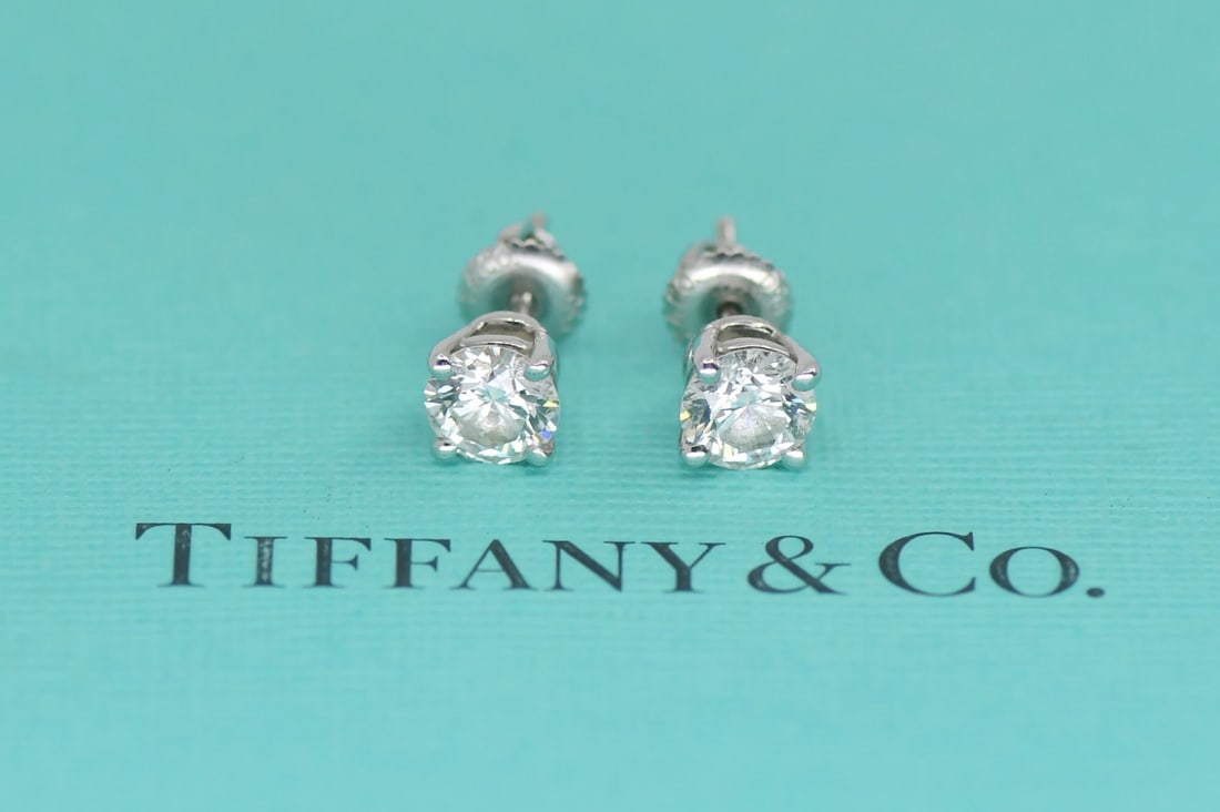 Tiffany & Co Platinum Diamond Stud Earrings 1.50 CTW H VS1: Tiffany & Co Platinum Diamond Stud Earrings 1.50 CTW H VS1 These Tiffany & Co. stud earrings feature two natural round diamonds with a combined total carat weight of 1.50 ct. The diamonds are graded H