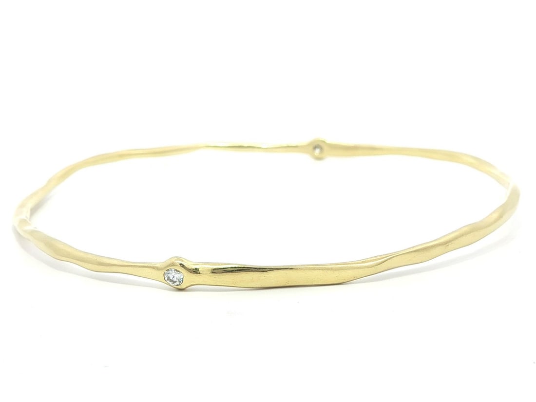 Slip On Bangle Bracelet in 18k Yellow Gold with 0.07ctw Bezel Set Diamonds: Slip On Bangle Bracelet in 18k Yellow Gold with 0.07ctw Bezel Set Diamonds This pre-owned slip-on bangle bracelet features two natural round brilliant cut diamonds bezel set in solid 18k yellow gold. 