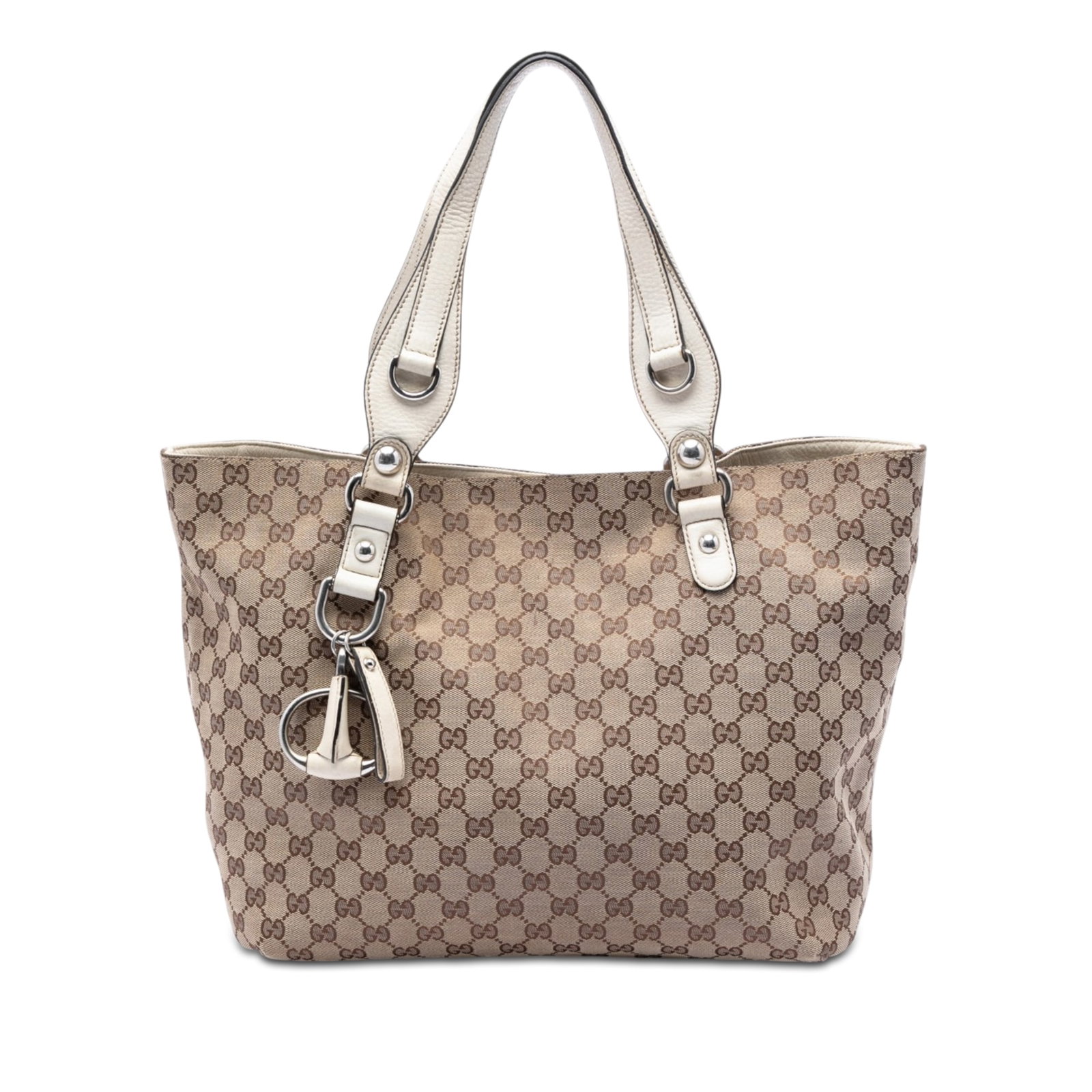 Gucci beige canvas tote with leather trim and magnetic snap: Gucci beige canvas tote with leather trim and magnetic snap This Gucci GG Canvas Icon Bit Tote is crafted with a beige canvas body and accented by leather trim. It features flat leather straps and an 