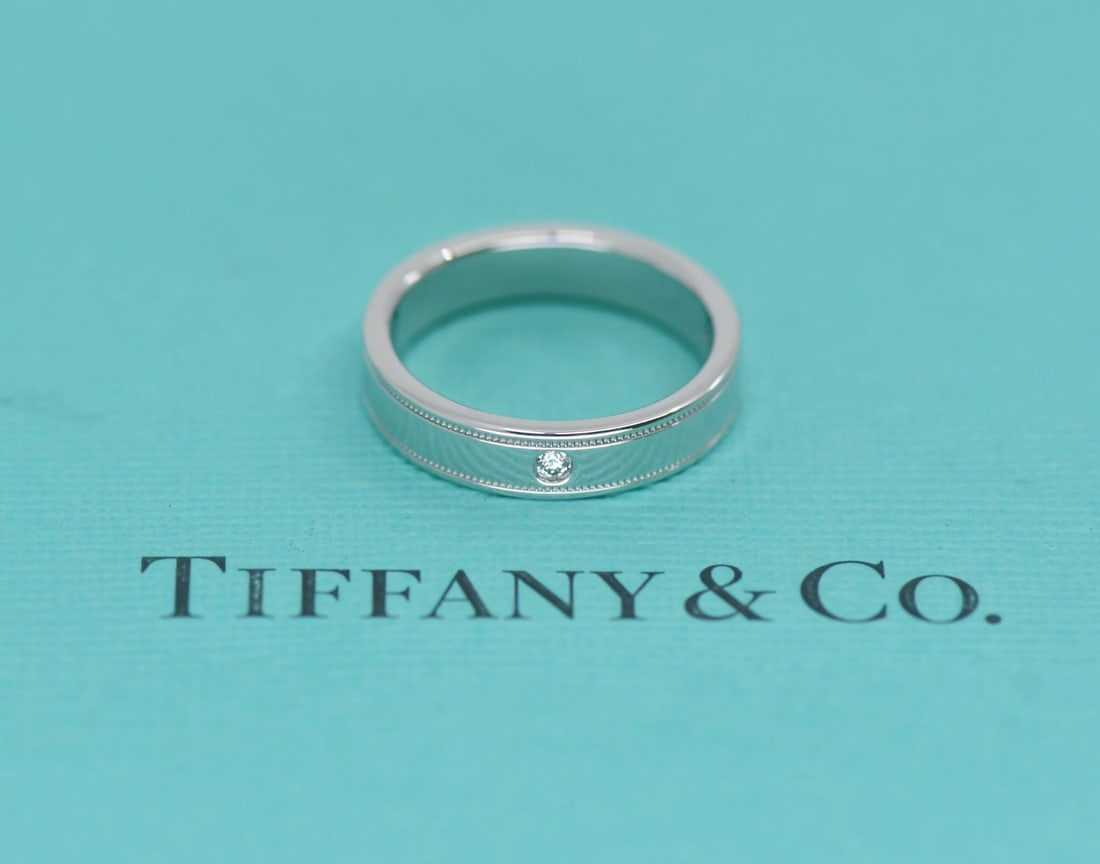 Platinum Diamond Milgrain Band by Tiffany Size 5: Platinum Diamond Milgrain Band by Tiffany Size 5 This Tiffany & Co. Double Milgrain ring is crafted from platinum with a metal purity of 950 and features diamond accents. The ring is designed in a siz
