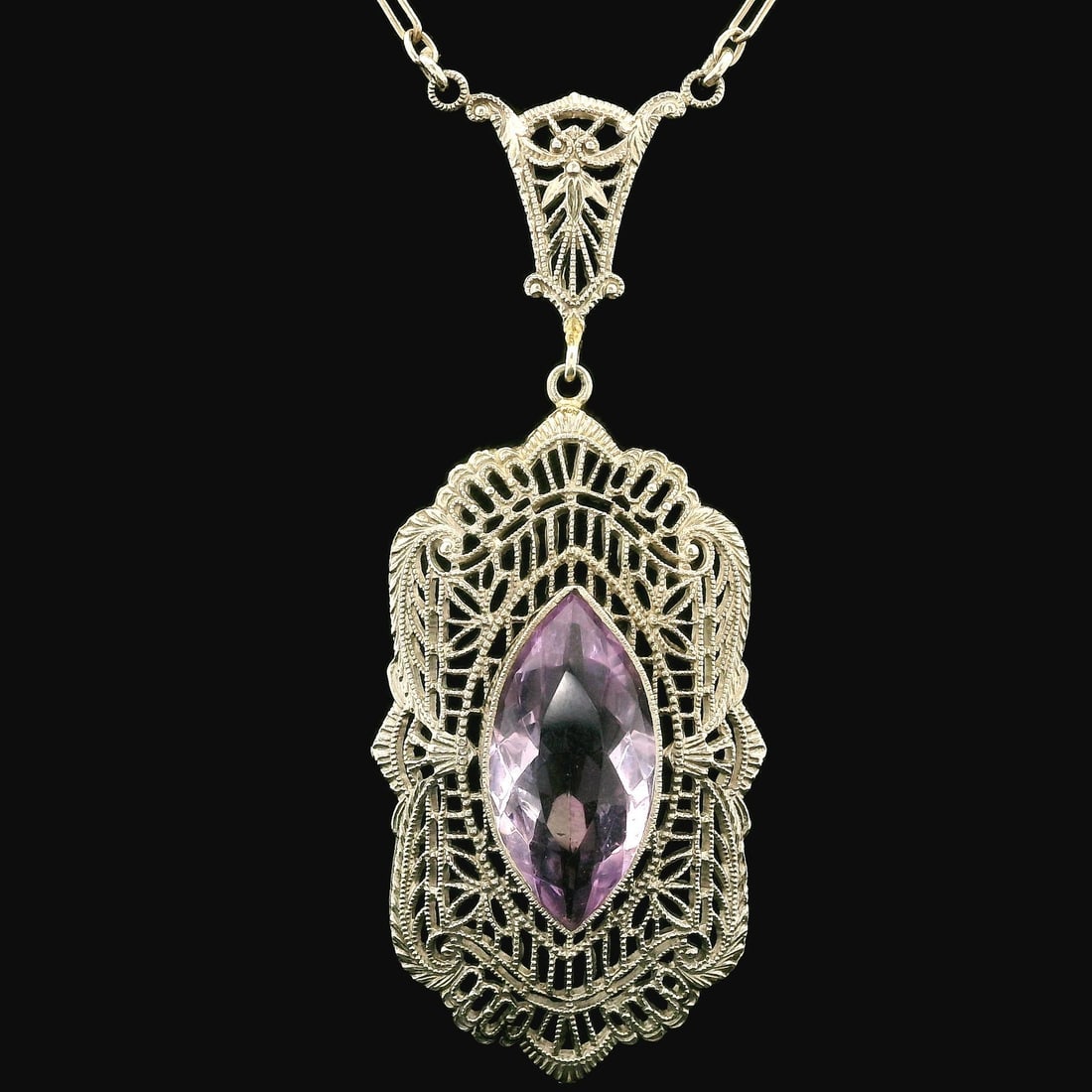 Antique Art Deco 10k White Gold Amethyst Filigree Pendant Necklace: Antique Art Deco 10k White Gold Amethyst Filigree Pendant Necklace This exquisite Antique Art Deco necklace features a stunning filigree design, crafted from solid 10k white gold. It showcases a natur