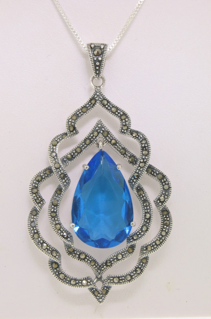 Stunning Sterling Silver Marcasite Blue Topaz Pear Pendant Necklace 18 Inch: Stunning Sterling Silver Marcasite Blue Topaz Pear Pendant Necklace 18 Inch This exquisite pendant necklace features a stunning simulated blue topaz in a pear cut, elegantly prong set within an intric