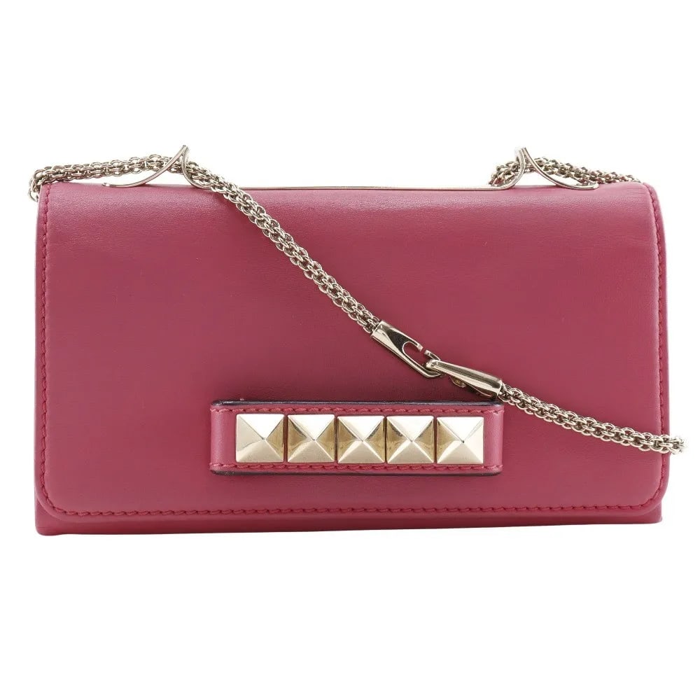 Va Va Voom Pink Leather Clutch by Valentino Garavani: Va Va Voom Pink Leather Clutch by Valentino Garavani This Valentino Garavani Va Va Voom clutch is crafted from pink leather and designed for women. It features a structured silhouette with Italian cra