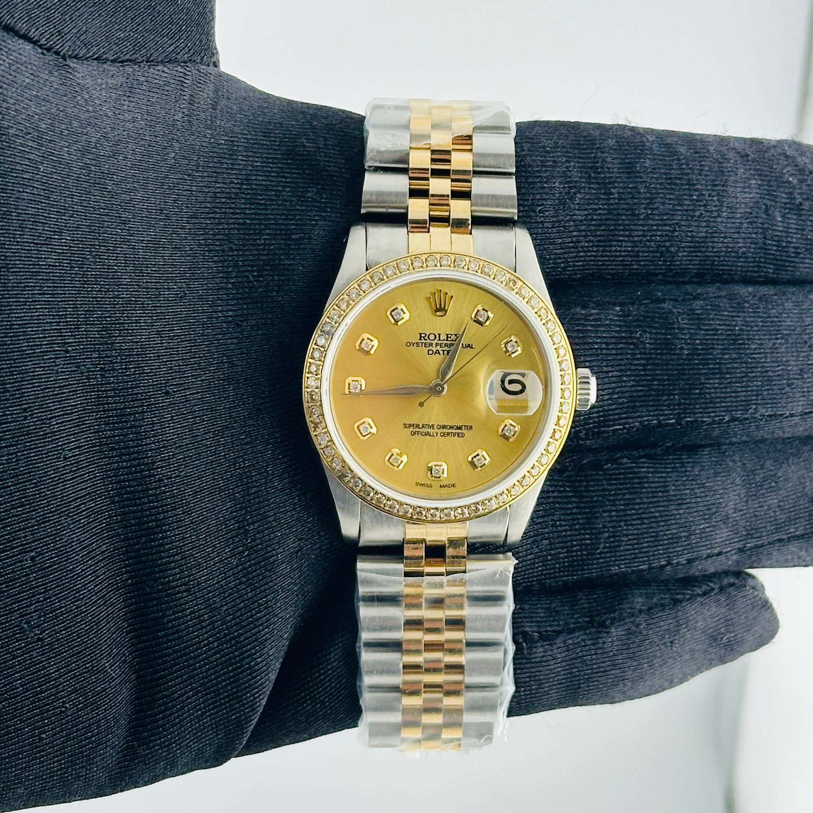 Rolex Date aftermarket Champagne Diamond Dial Jubilee Bracelet Ref 6694: Rolex Date aftermarket Champagne Diamond Dial Jubilee Bracelet Ref 6694 This watch features a champagne diamond dial and a pave plated diamond bezel, paired with an aftermarket Jubilee bracelet. The r