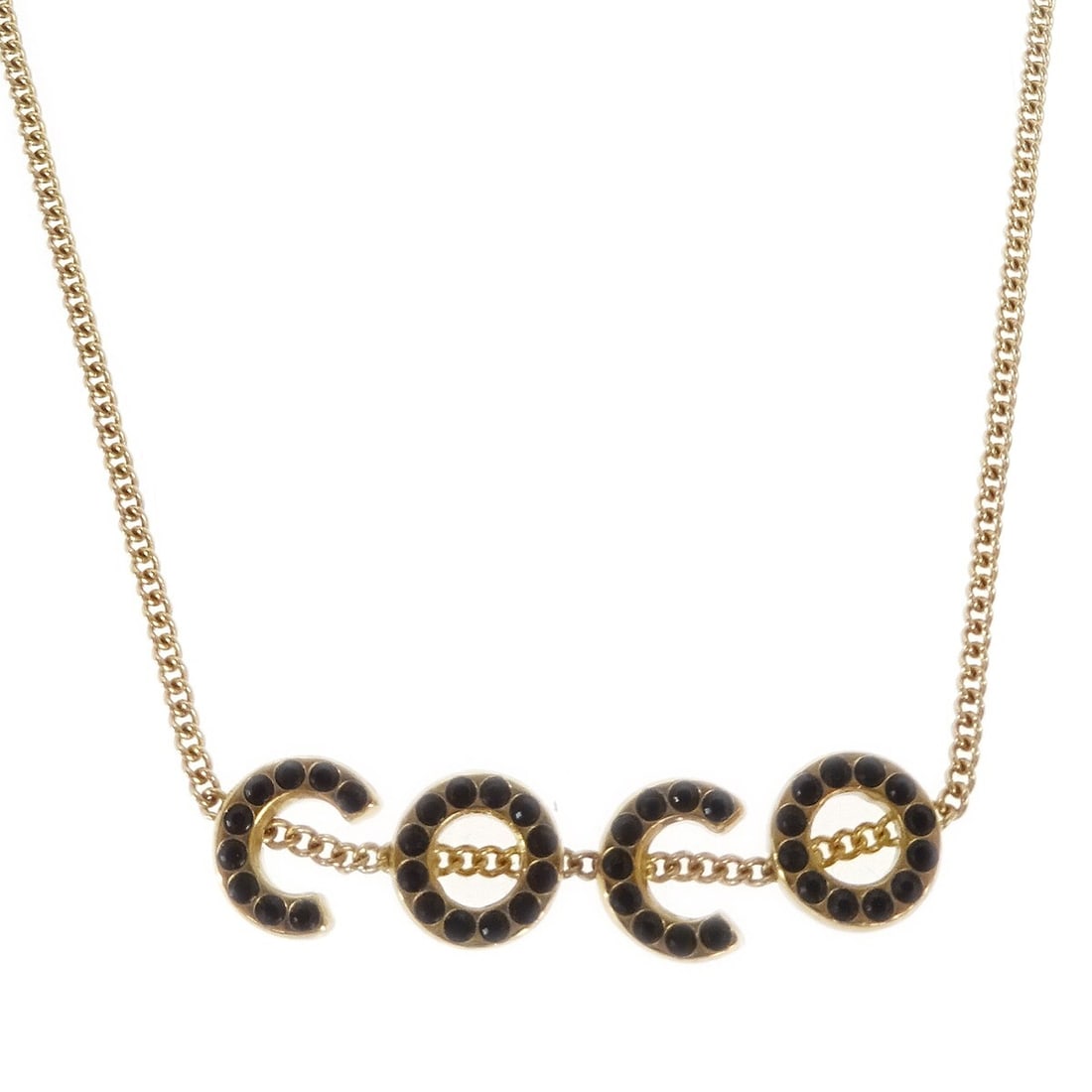 Chanel COCO Gold Plated Rhinestone Pendant Necklace 01A: Chanel COCO Gold Plated Rhinestone Pendant Necklace 01A Vintage Chanel pendant necklace featuring a COCO charm design with rhinestone detailing in gold and black. This gold-plated necklace is made in 