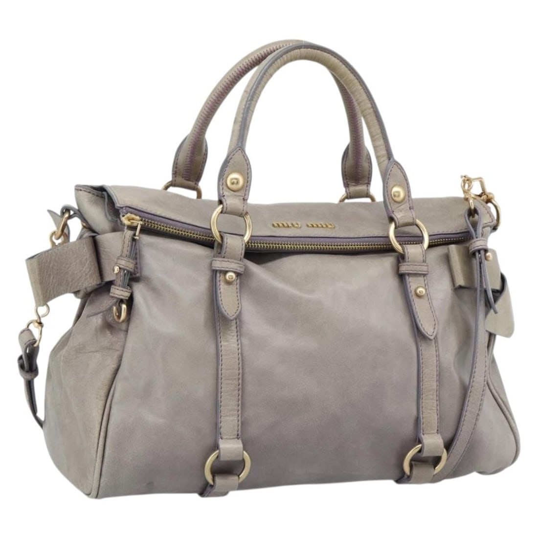Miu Miu Purple Leather 2way Handbag with Shoulder Strap: Miu Miu Purple Leather 2way Handbag with Shoulder Strap Purple leather 2-way handbag with ribbon detailing and gold-tone accents. This women's bag includes a shoulder strap and can be carried by the h
