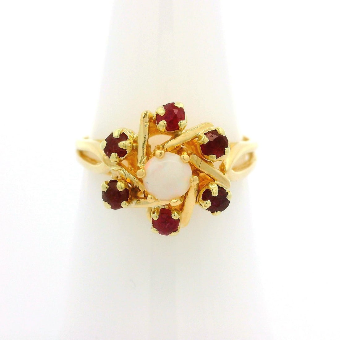 Vintage 14k Yellow Gold Opal Ruby Flower Cocktail Ring: Vintage 14k Yellow Gold Opal Ruby Flower Cocktail Ring This exquisite vintage cocktail ring features a stunning open flower design, crafted from 14k yellow gold. At its center, a natural genuine white