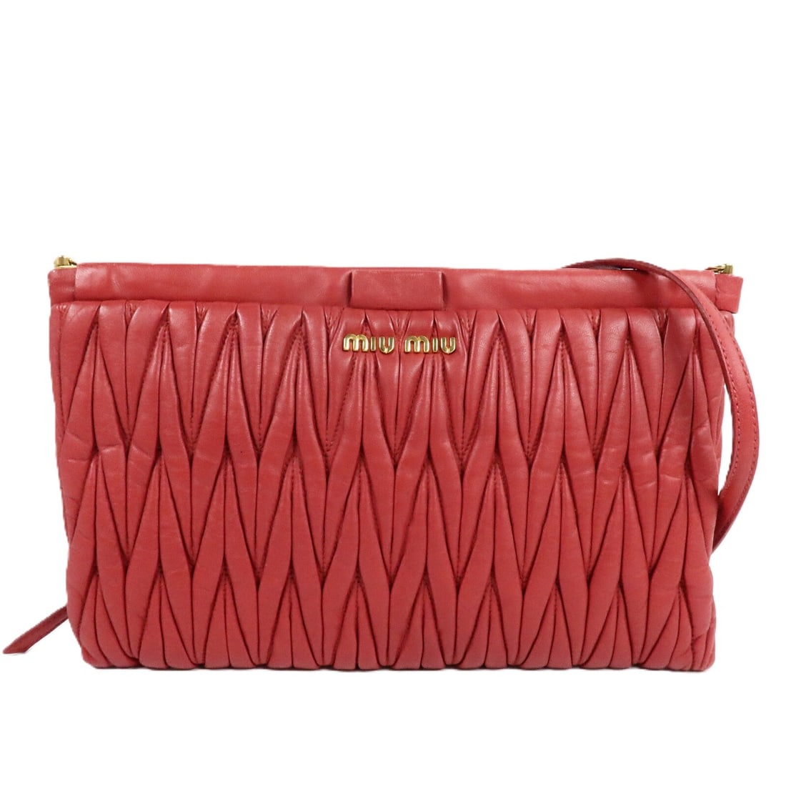 Miu Miu red lambskin clutch shoulder bag with strap: Miu Miu red lambskin clutch shoulder bag with strap A Miu Miu shoulder clutch bag in red lambskin leather with a shoulder strap. It features a practical interior layout with two open pockets and one i