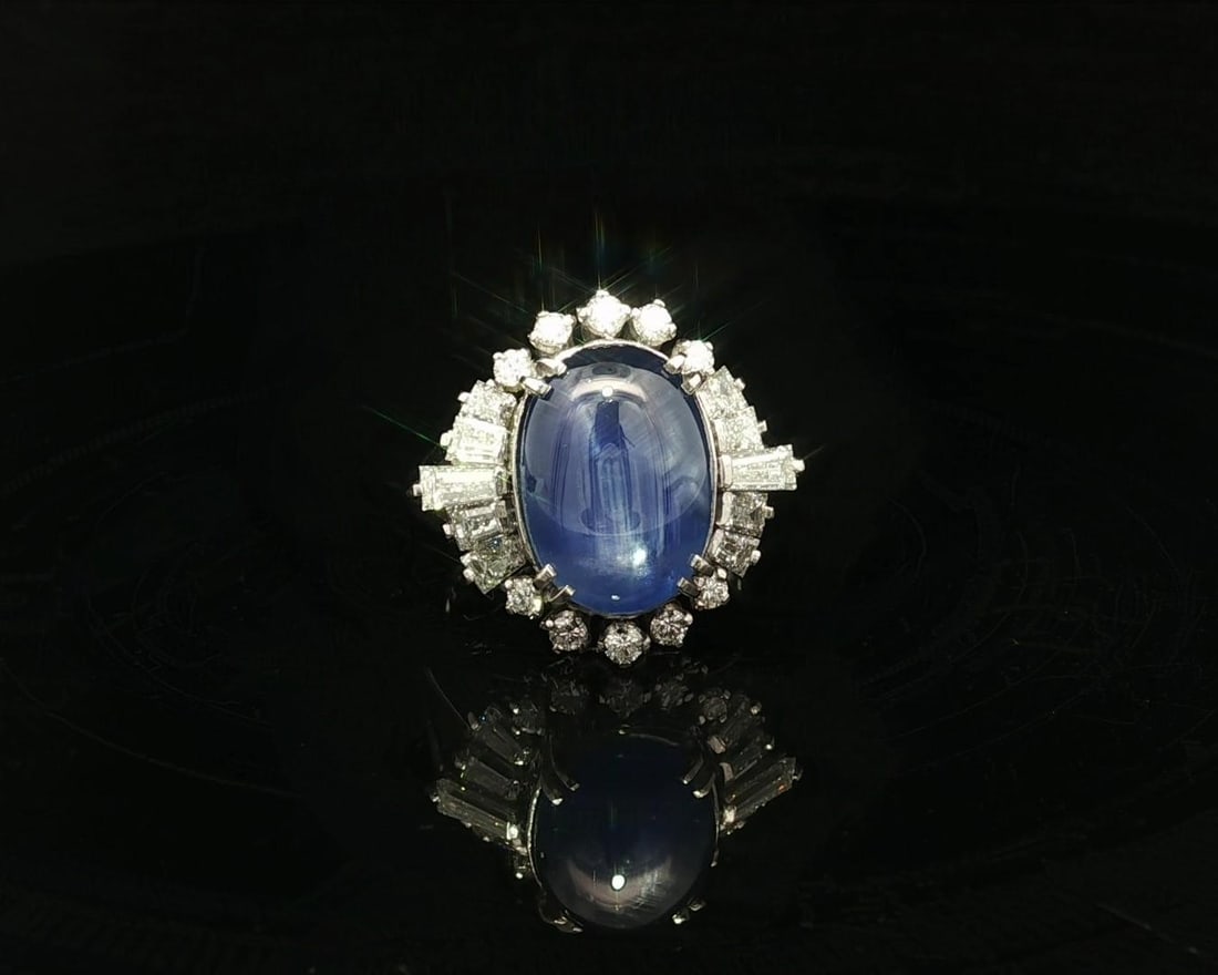 Platinum Ring with GIA Certified No Heat Ceylon Blue Star Sapphire and Diamonds: Platinum Ring with GIA Certified No Heat Ceylon Blue Star Sapphire and Diamonds This platinum cocktail ring features a natural, no-heat Ceylon star sapphire weighing 7.16 carats, showcased in an oval 