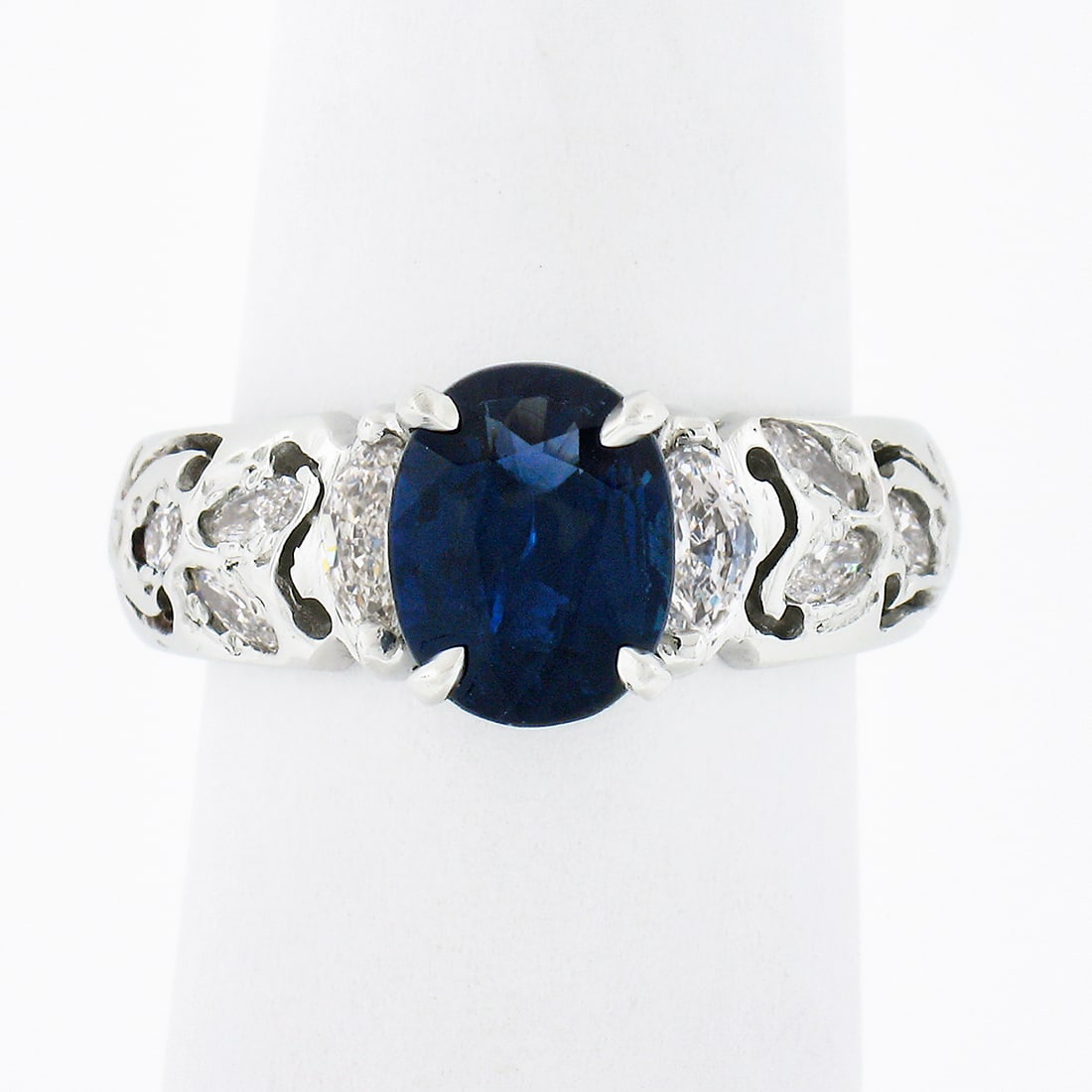 Platinum 2.59ct Oval Sapphire Engagement Ring with Marquise Diamonds: Platinum 2.59ct Oval Sapphire Engagement Ring with Marquise Diamonds This exquisite engagement ring features a stunning 2.59ct oval sapphire at its center, elegantly complemented by marquise-cut diamo