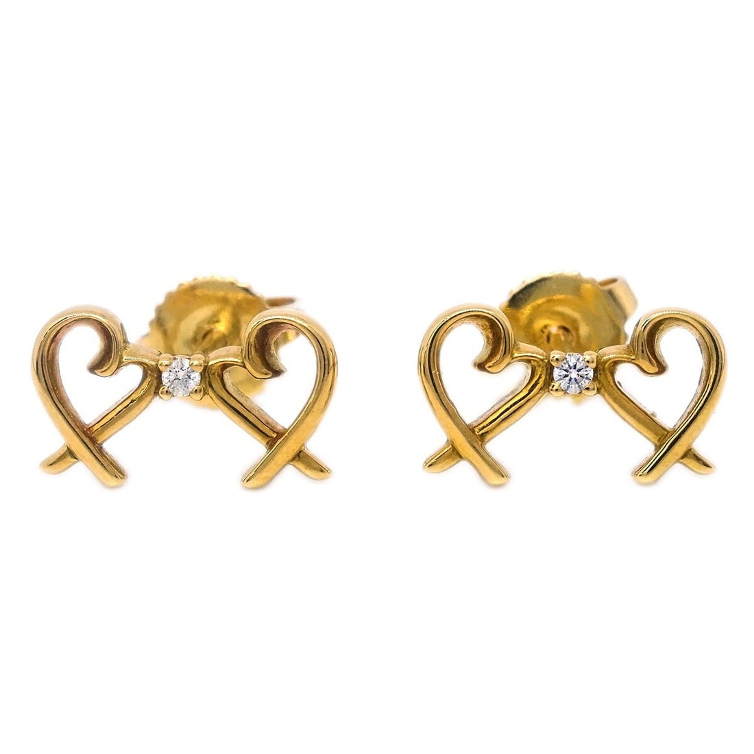 Tiffany & Co. Double Loving Heart Earrings 18K Gold Diamond Pair: Tiffany & Co. Double Loving Heart Earrings 18K Gold Diamond Pair A pair of Tiffany & Co. pierced earrings in a double loving heart design, crafted in 18K gold (Au750) with diamond accents. The earring