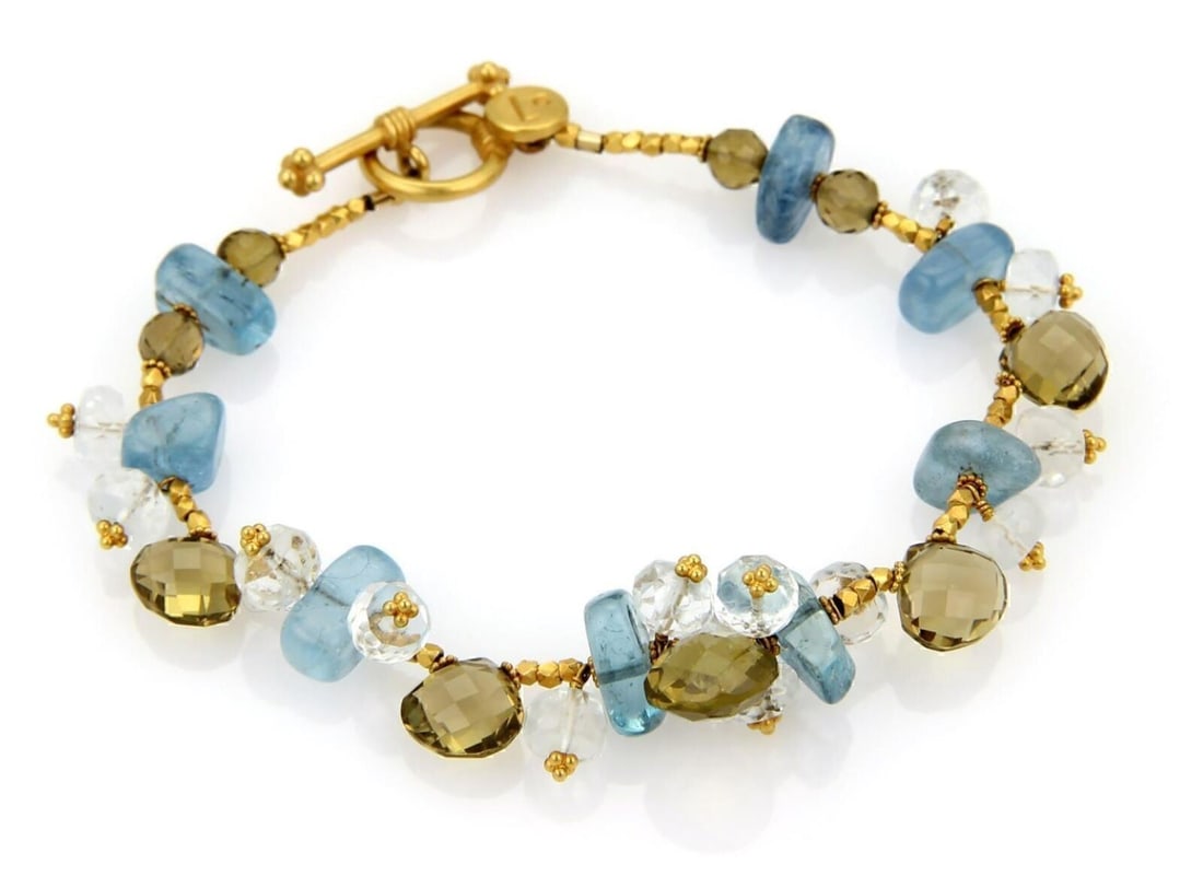 Laura Gibson 22k Yellow Gold Toggle Bracelet with Multicolor Gemstone Beads: Laura Gibson 22k Yellow Gold Toggle Bracelet with Multicolor Gemstone Beads This pre-owned Laura Gibson toggle bracelet is crafted in 22k yellow gold and features multi-color gemstone bead clusters. I