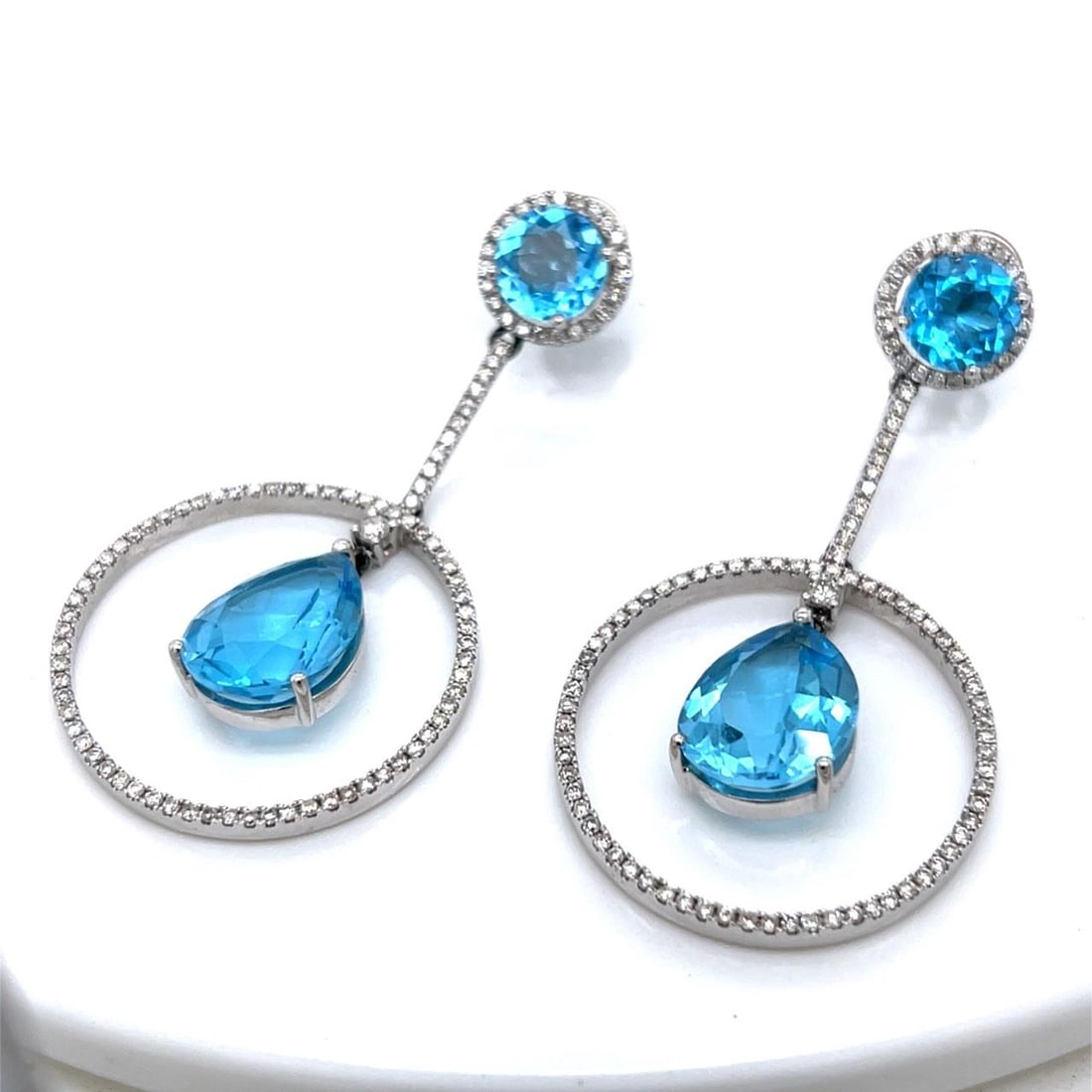 White Gold Earrings with Topaz and Diamond Accents 14K 2 Inch: White Gold Earrings with Topaz and Diamond Accents 14K 2 Inch These 14K white gold earrings feature approximately 1.00 carat of diamonds with H-I color and SI1-SI2 clarity, complemented by four topaz 