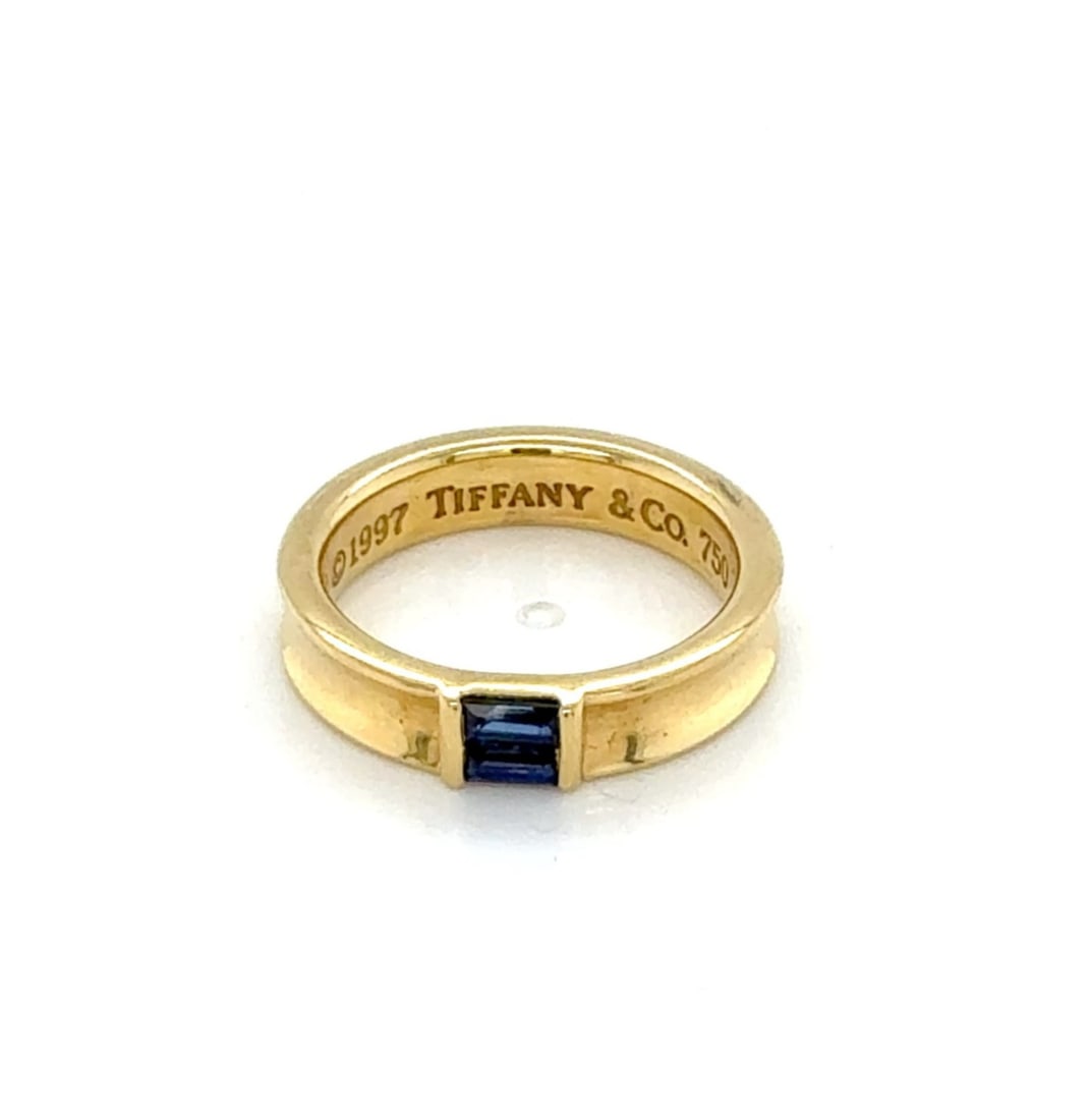 Tiffany & Co. Baguette Sapphire Band Ring 18k Yellow Gold Size 6: Tiffany & Co. Baguette Sapphire Band Ring 18k Yellow Gold Size 6 This Tiffany & Co. baguette sapphire band ring is crafted in 18k yellow gold and features natural channel-set baguette sapphires across