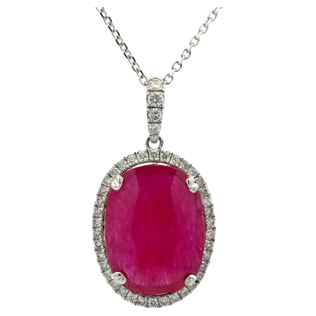 Oval Ruby and Diamond Halo Pendant Necklace in 14K White Gold 6.85 Carat: Oval Ruby and Diamond Halo Pendant Necklace in 14K White Gold 6.85 Carat This elegant pendant necklace features a striking oval cut ruby weighing approximately 6.85 carats, surrounded by a delicate