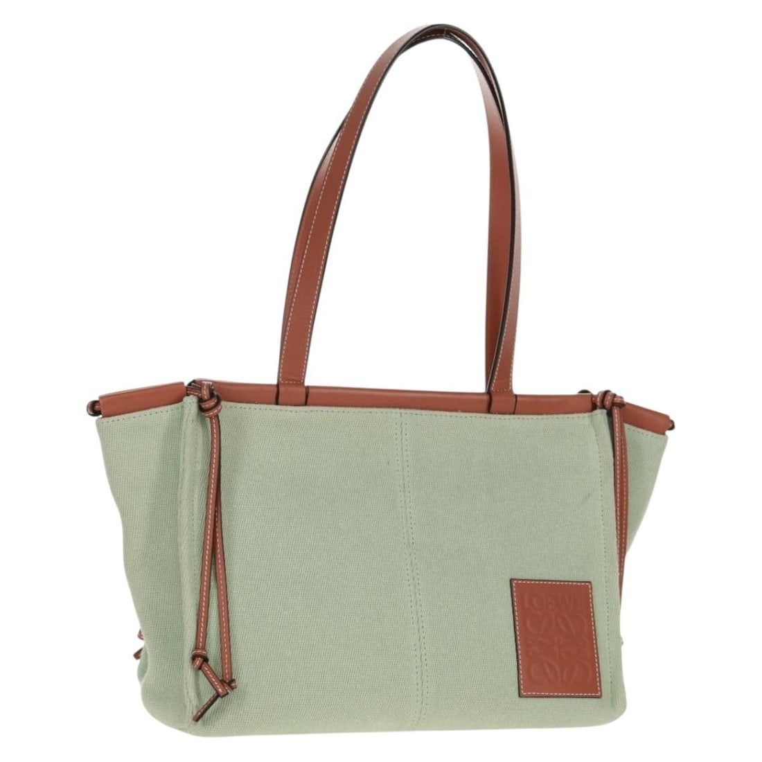 Loewe Anagram Canvas Tote in Light Green with Dust Bag: Loewe Anagram Canvas Tote in Light Green with Dust Bag This LOEWE Anagram Cushion Tote Bag features a light green canvas exterior and a spacious design. The tote includes a dust bag accessory and is c