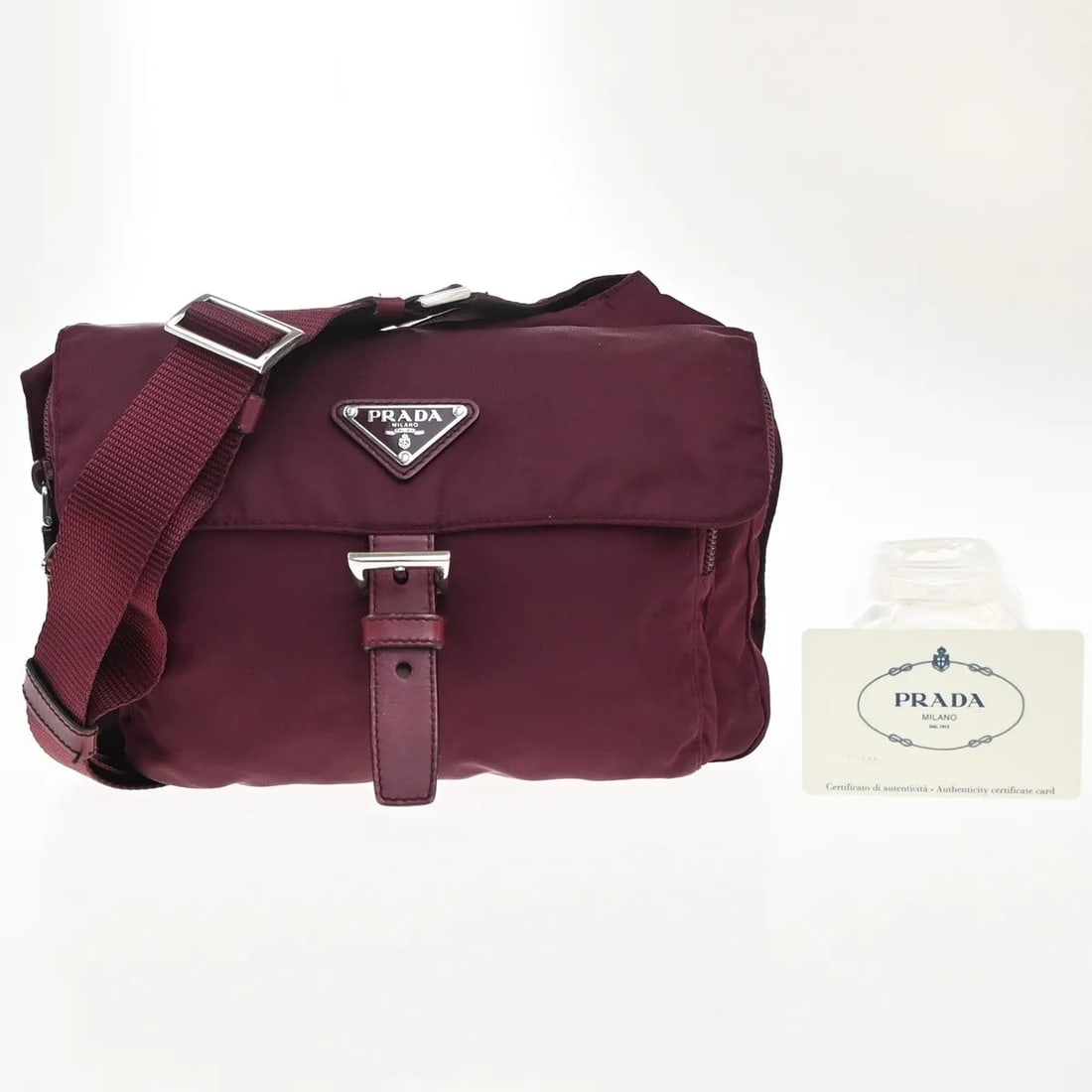 Prada Red Nylon Messenger Bag with Printed Design: Prada Red Nylon Messenger Bag with Printed Design This Prada Messenger Bag showcases a vibrant red color and is crafted from durable nylon. Designed specifically for women, it features a printed patte