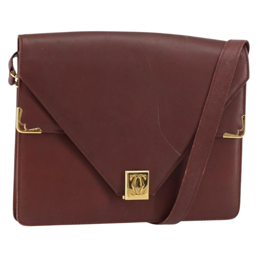 Cartier Must de Cartier Burgundy Leather Shoulder Bag: Cartier Must de Cartier Burgundy Leather Shoulder Bag This pre-owned Must de Cartier shoulder bag for women features burgundy leather construction with metal fittings. It exhibits signs of use includi