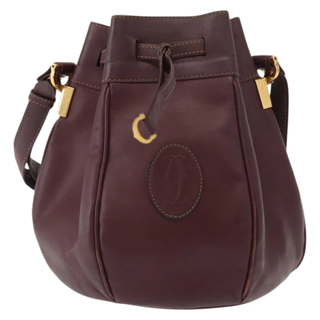 Cartier Must de Cartier Burgundy Leather Handbag: Cartier Must de Cartier Burgundy Leather Handbag Cartier Must de Cartier leather bag in burgundy. Made in France, this piece shows fair overall condition with light surface wear, moderate deformation,
