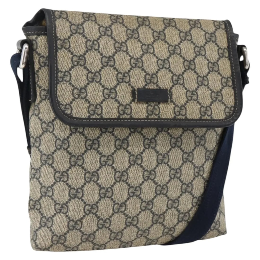 Navy GG Canvas Flap Messenger Bag by Gucci Unisex: Navy GG Canvas Flap Messenger Bag by Gucci Unisex This Gucci Flap Messenger bag features GG coated canvas in navy. Designed for unisex use, it offers a practical flap closure and an adjustable shoulde